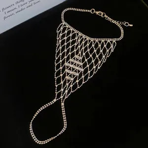 Intricate hollow mesh silver slave bracelet featuring a connected ring and beaded chain