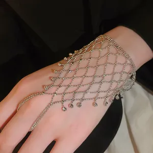 Close-up detail of a silver hollow mesh hand harness with delicate fringe beads