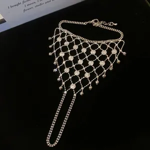 Close-up of elegant silver hollow mesh slave bracelet with finger ring on black velvet