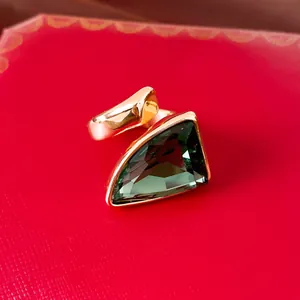 Detailaufnahme eines Vintage-Rings mit großem dreieckigen grünen Edelstein.