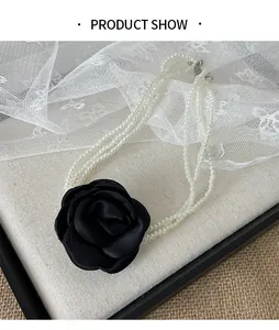 Detailansicht eines mehrlagigen Perlen-Chokers mit einer schwarzen Stoffblume