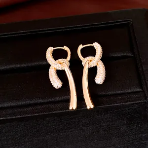 Close-up detail of 18k gold plated drop earrings featuring sparkling cubic zirconia stones