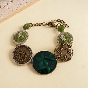 Close-up of vintage resin bracelet with green drip-oil flower and leaf patterns.