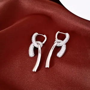 Detailed macro view of 18k gold plated drop earrings with sparkling cubic zirconia stones