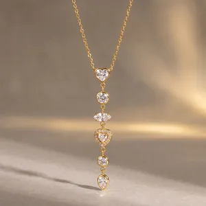 Macro view showing detail of a gold-plated stainless steel necklace with heart zircon charms