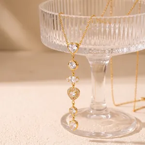 Detailed view of gold stainless steel necklace with heart-shaped cubic zirconia charms