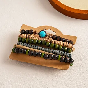 Detail view of 5-piece set ethnic wooden beaded elastic bracelets on card.