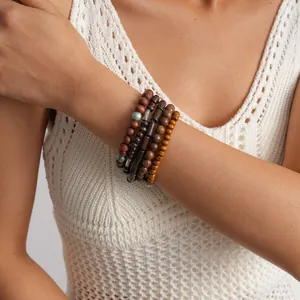 Close-up of 5pcs ethnic wooden beaded elastic bracelets set on a model wrist