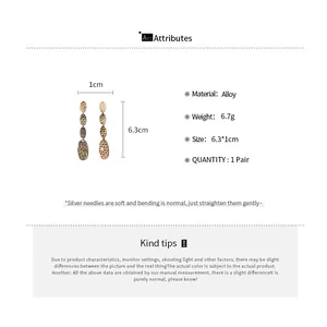 Détails de boucles d'oreilles pompons ovales avec aiguilles d'argent