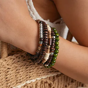 Detailed view of 5-piece ethnic wooden beaded bracelets with engraved silver bead.