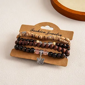 Detail view of 5-piece bohemian wooden bead bracelet set with butterfly charm
