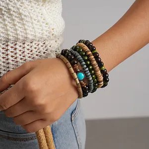 Detailed shot of ethnic five-piece wooden beaded bracelets set worn on a female wrist