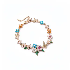 18k gold plated bracelet featuring colorful floral and butterfly charms with cubic zirconia