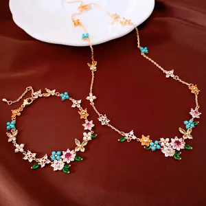 Elegant 18k gold plated flower and butterfly jewelry set featuring necklace and bracelet detail