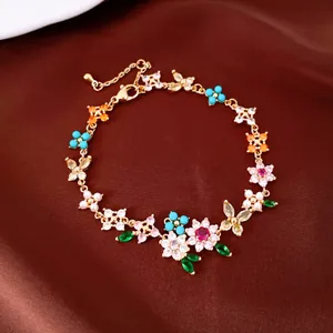Detailed view of 18k gold plated bracelet with colorful CZ flowers and butterflies
