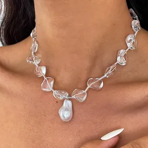 Close-up detail of a baroque pearl pendant necklace with clear irregular glass beads
