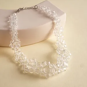 Close-up macro shot showing faceted clear glass beads of a chunky fashion necklace