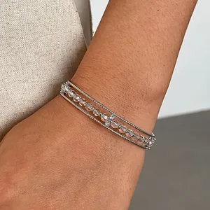 Macro detail of triple-layer bracelet with clear faceted glass beads and silver twisted chains