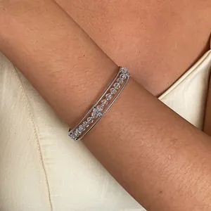 Detail shot of a minimalist triple-strand silver bangle with sparkling glass beads