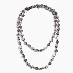 Vintage iridescent shell disc and glass bead layered necklace for a retro chic look.