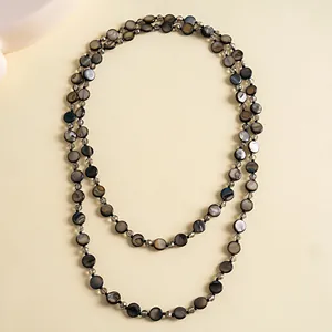 Vintage double-layered necklace featuring dark shell discs and faceted glass beads