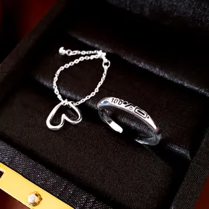Detailed shot of silver heart chain ring with 100% engraving in jewelry box
