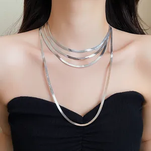 Gros plan d'un élégant collier à plusieurs rangs en maille serpent argentée sur modèle