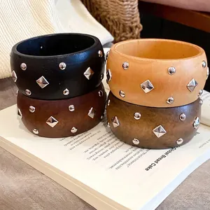 Set aus Holz-Armreifen im Retro-Stil mit geometrischen Silbernieten und Rauten-Studs