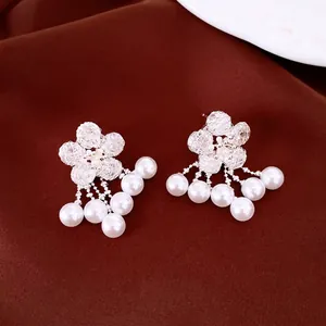 Elegant silver flower stud earrings with cascading pearl tassels