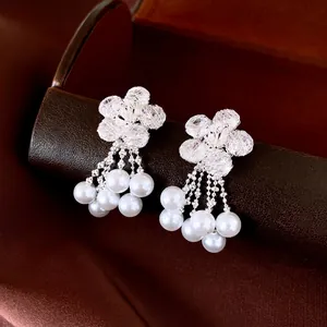 Elegant silver flower earrings featuring zircon studs and flowing white pearl tassels