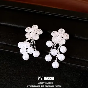 Elegant silver flower earrings with shimmering zircon petals and pearl tassel drops