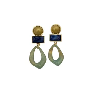 Vintage geometric acrylic pendant earrings with gold and blue accents.
