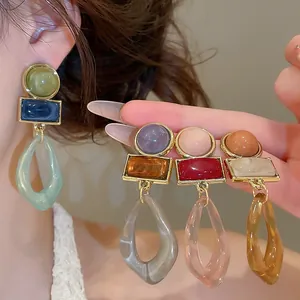 Detailed close-up view of vintage acrylic geometric drop earrings in multiple colors