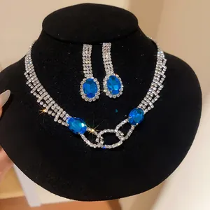 Exquisite silver necklace and earring set with shimmering blue oval rhinestones