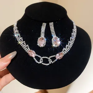 Detailed view of elegant necklace and earring set featuring pink oval gemstones and crystals.