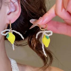 Sweet resin lemon stud earrings featuring delicate white pearl bow fringe design for women