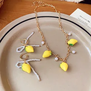 Elegant sweet resin lemon and pearl necklace and earring jewelry set in golden finish style
