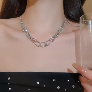 Close-up of elegant rhinestone necklace with pink gemstones on model for evening party