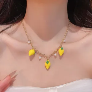 Close-up of a sweet resin lemon and pearl tassel necklace worn on a collarbone