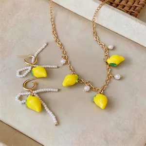 Summer lemon pendant pearl jewelry set featuring gold-toned necklace and earrings