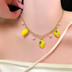 Charming fresh lemon pendant necklace with pearls for a sweet summer style statement.