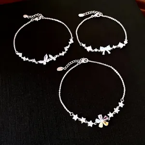 Elegant silver-tone zircon bracelets with butterfly and flower charms on black background