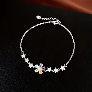Elegant silver flower bracelet featuring colorful zircon petals on a black background