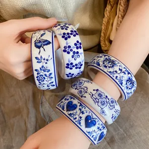 Detailed view of elegant blue and white floral resin bangles with butterfly patterns