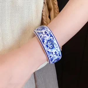 Detail view of Chinoiserie blue and white floral pattern on vintage resin bangle bracelet