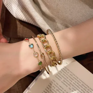 Detailansicht eines Sets aus Herz-Perlenarmband und goldener grober Gliederkette für Damen