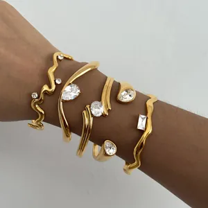 Detail view of stackable 18k gold plated stainless steel bangles with zircon stones