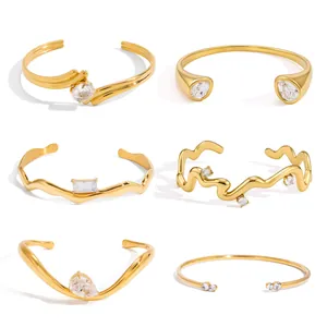 Detailed collection of gold plated stainless steel bangles with various zircon settings.