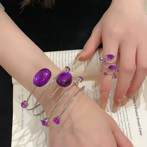 Gros plan d'un ensemble bracelet et bague bohème en argent avec pierres violettes