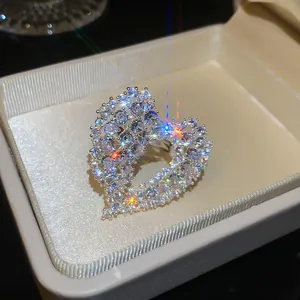 Detailed macro view of a sparkling zirconia heart-shaped open ring in a jewelry box.